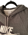 Gray Nike hoodie on a hanger with a white background